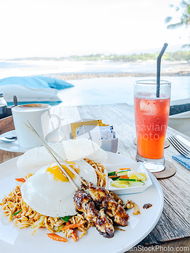 Image of Indonesian food, mie goreng and chicken satay