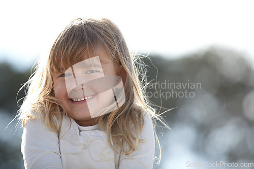 Image of Nature, smile and portrait of girl child with positive, good and confident attitude in an outdoor park. Happy, cute and young kid from Canada with sweet personality in a field, garden or backyard.