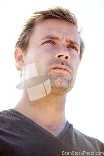 Image of Thinking, serious and young man in a studio with brainstorming, ideas or planning facial expression. Handsome, confident and male person from Canada with wonder or dreaming face by white background.