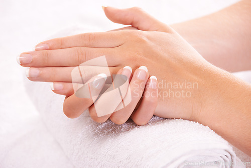 Image of Woman, hands and french manicure in spa, salon and cosmetic care, skincare and beauty. Natural tips, wellness and treatment for hygiene, closeup and nail parlour with towel, clean and maintenance