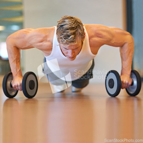Image of Man, gym and pushup on floor, dumbbells or workout for muscle development, growth and results for health. Person, exercise and bodybuilder with training process, strong arms and progress for wellness