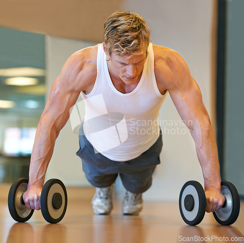 Image of Man, workout and pushup on floor, dumbbells or gym for muscle development, growth and results for health. Person, exercise and bodybuilder with training process, strong arms and progress for wellness