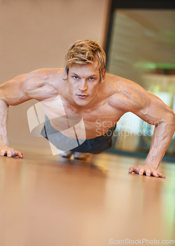 Image of Man, exercise and pushup on floor, fitness and workout for muscle development, growth and results for health. Person, gym and bodybuilder with training process, strong arms and progress for wellness