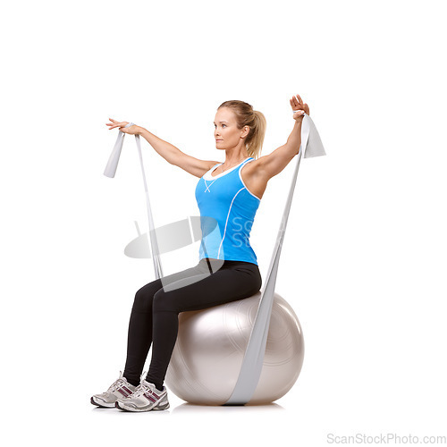 Image of Yoga ball, resistance band and woman doing exercise in studio for health, wellness and body care. Sports, fitness and young female person from Canada with arms workout or training by white background