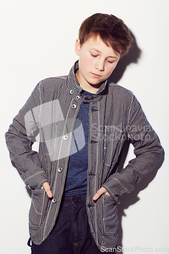 Image of Sad, teenager and insecure boy in studio, white background or thinking about fashion. Child, anxiety and worry for style, clothes and struggle with emotions, thoughts and personality in backdrop
