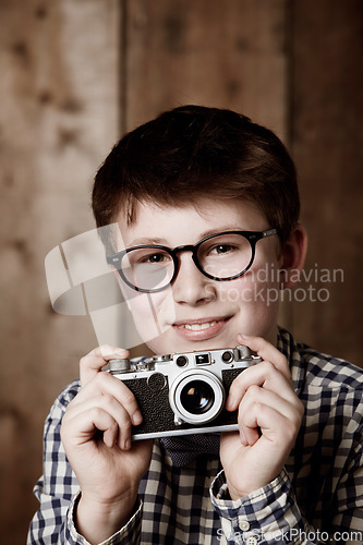 Image of Portrait, child and vintage for camera with happiness, mockup and positive in glasses by backdrop. Boy, smile face and nerd with photography in retro clothes and eyewear for creative kids with vision