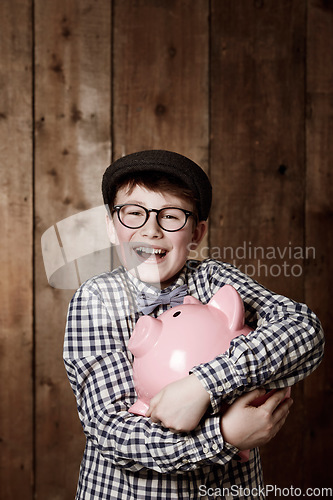 Image of Piggy bank, hug and portrait of boy child with savings, growth or investment success in his home. Finance, learning and face of excited kid with money box for future education, funding or security