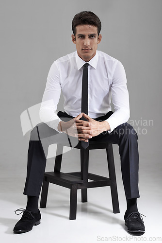 Image of Shirt, tie and portrait of businessman with chair in studio, grey background and mock up space. Confident, man and entrepreneur sitting on stool with commitment, pride and attention in backdrop