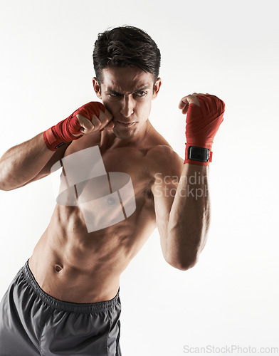 Image of Man, kick boxer and topless in gym, serious and face for workout, boxing and strong. Exercise, sports and training for power, self defense and concentration for challenge, mma and fighting skills