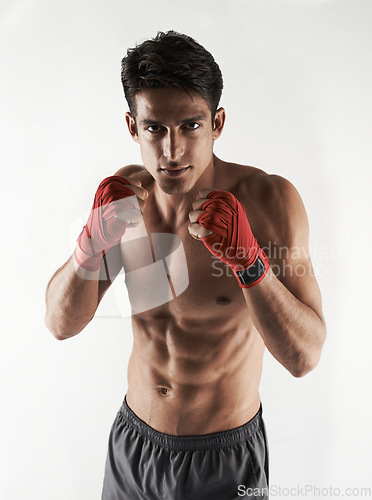 Image of Man, kick boxer and portrait in gym, serious and face for workout, boxing and strong. Exercise, sports and training for power, self defense and concentration for challenge, mma and fighting skills