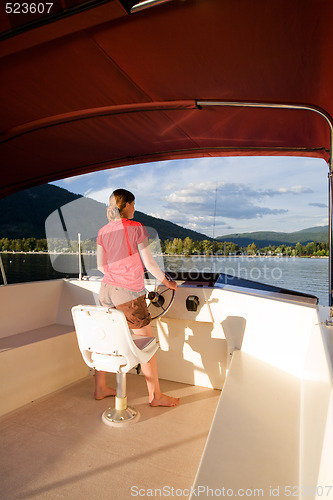 Image of Woman Driving a Yacht