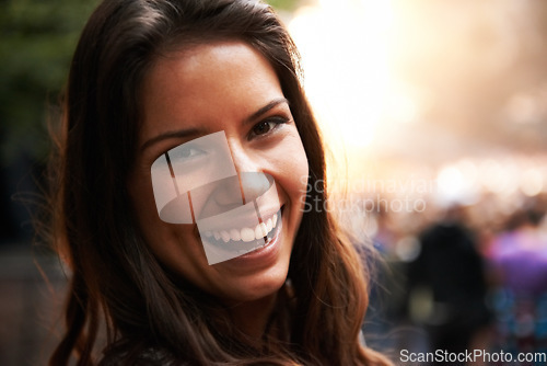 Image of Portrait, smile and a young woman at a music festival for energy, freedom or celebration outdoor. Face, party and excitement with a happy person in the crowd or audience of a concert performance