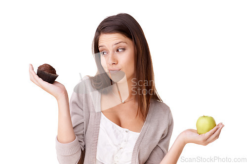 Image of Doubt, decision and apple or muffin with a woman in studio isolated on a white background for food choice. Unsure, diet or nutrition with a confused young person holding fruit and dessert options