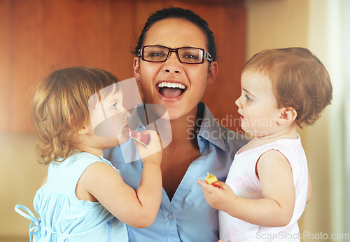 Image of Portrait, happy woman and stress with children in home with snack, fruit or apple slice for eating. Female person, remote work and multitask for productivity, job and childcare with kids in a house