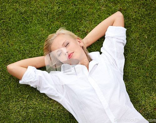 Image of Relax, peace and woman sleeping on grass with zen, free or day off top view nap outdoor. Garden, dreaming and above female person resting in nature, wellness and enjoying me time, break or weekend