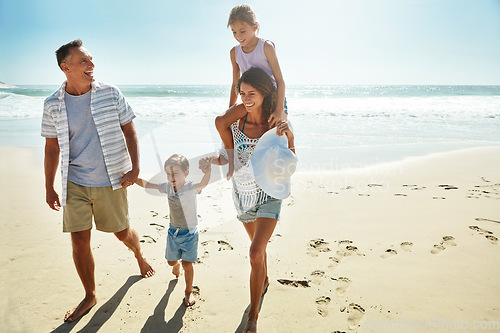 Image of Parents, children and beach for summer travel vacation, ocean sunshine or sibling together. Man, woman and kid piggy back on sand for family holiday or outdoor clean air, sea relax or love nature