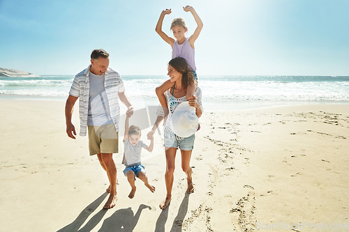 Image of Parents, children and swing on beach holiday for travel sunshine, ocean piggy back or sibling development. Man, woman and kid playful on sand for vacation walk or outdoor, sea relax or love nature