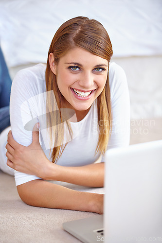 Image of Woman, remote work and portrait with laptop on floor of home to update blog post, social media and digital subscription. Happy freelancer relax with computer for online shopping, email and research