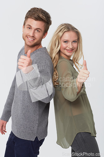 Image of Portrait, smile and couple with thumbs up for success, choice or agreement together. Happy man, woman and like hand sign, gesture or emoji in love recommendation isolated on a white studio background