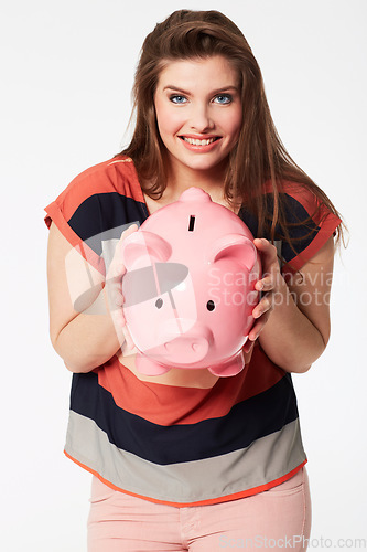 Image of Finance, portrait and woman with piggy bank in studio for savings, payment our budget on white background. Money, box or face of person with cash container for investment or future financial freedom