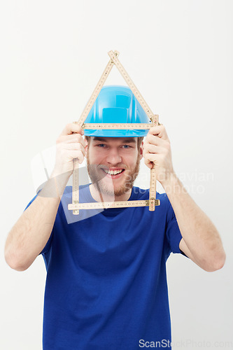 Image of Carpenter man, ruler and studio portrait with smile, security and helmet for construction by white background. Person, handyman or architect with measuring, maintenance and building in wood industry