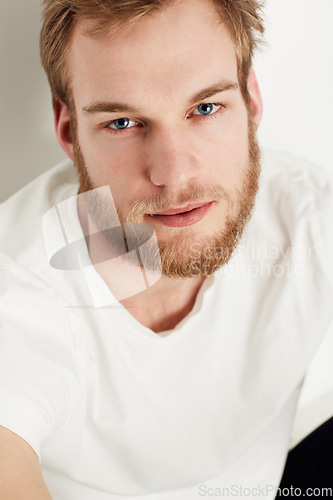 Image of Man, portrait and confident or fashion in studio with casual style, trendy outfit and calm expression. Person, face and relaxing, tshirt and satisfaction with peace and pride on white background