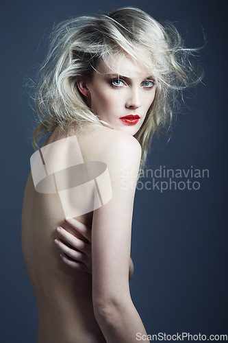 Image of Portrait, beauty and body of nude woman in studio isolated on a blue background mockup space. Face, makeup cosmetics and confident naked female model, sexy skin and serious blonde person in lipstick