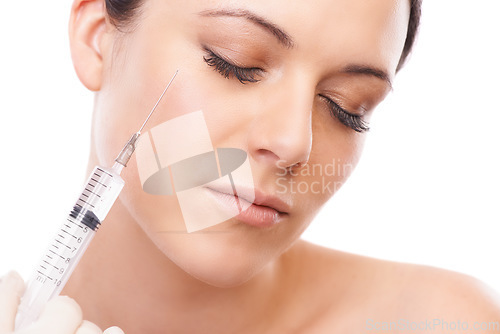 Image of Woman, face and needle for plastic surgery in studio for injection, chemical or product by white background. Girl patient, person and syringe for change, transformation or results for facial beauty