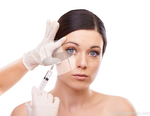 Image of Woman, portrait and syringe for plastic surgery in studio for injection, chemical and product by white background. Girl patient, surgeon and needle for change, transformation and results with beauty