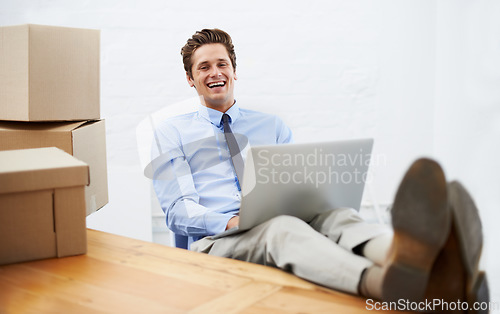 Image of Businessman, moving boxes and happy on laptop, portrait and online logistics for courier delivery. Male person, professional and laughing for company distribution, package and shipment by internet