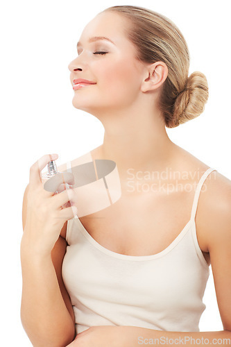 Image of Woman, makeup and beauty with perfume, face and model for scent, cosmetics on white background. Skin, fragrance and smile with shine, skincare or clean for facial glow, cosmetology or grooming