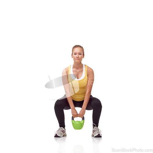 Image of Fitness, portrait and woman exercise with kettlebell swing, squat or workout for muscle growth, arm strength or bodybuilding. Studio, weightlifting hard work and athlete training on white background