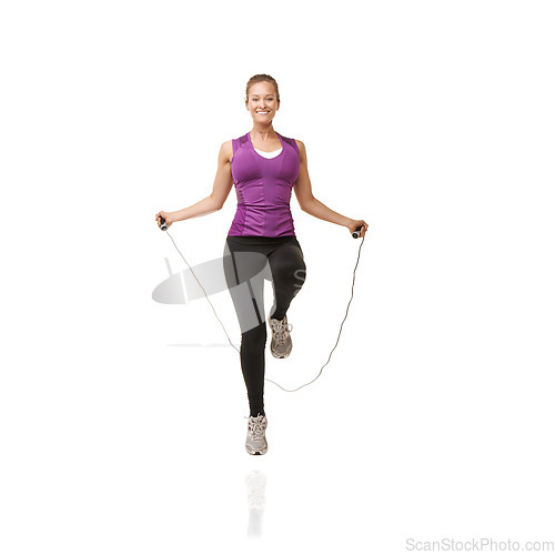 Image of Fitness, skipping rope and portrait of woman on a white background for exercise, cardio workout and training. Sports, studio and isolated person with gym equipment for health, wellness and jumping