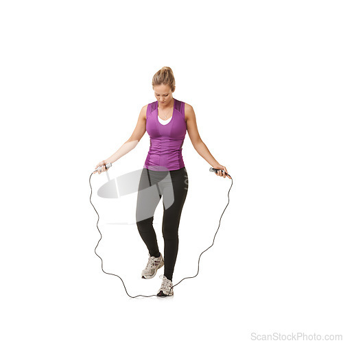 Image of Fitness, skipping rope and woman on a white background for training, cardio workout and exercise. Sports, endurance and isolated person with gym equipment for health, wellness and jumping in studio