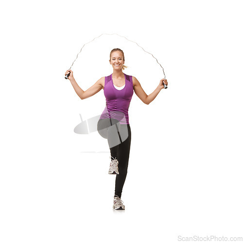 Image of Portrait, skipping rope and woman on a white background for exercise, cardio workout and training. Sports, fitness and isolated person with gym equipment for health, wellness and jumping in studio