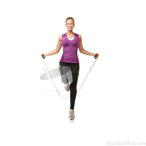 Image of Portrait, skipping rope and woman on a white background for cardio workout, exercise and training. Sports, fitness and isolated person with gym equipment for health, wellness and jumping in studio