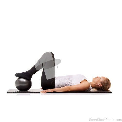 Image of Yoga, exercise and woman on floor with ball for pilates, wellness care and health in studio. Gym, training and girl on mat with workout, lying and muscle fitness isolated on white background.