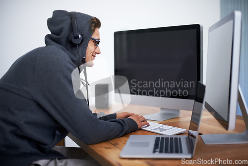 Image of Man, hoodie and hacker on computer for digital information for password error, cyber security or database glitch. Male person, dual screen and online programming for malware code, stealing or network