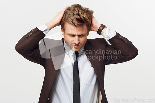 Image of Stress, burnout and mistake with a business man in studio isolated on a white background for error. Anxiety, fail and frustration with a young employee looking worried in a suit for corporate work