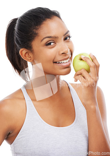 Image of Young woman, apple and eating of healthy food for nutrition, detox and wellness in a studio portrait. Happy african person with green fruit for smile, lunch or vegan choice on a white background