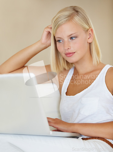 Image of Young woman, laptop and relax on sofa with online streaming service for website, movie or social media. Person watch or reading on her computer for internet search and subscription on a couch at home