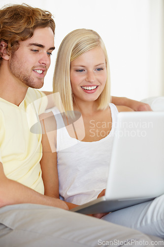 Image of Love, laptop and couple relax on sofa with social media, movies or streaming at home together. Online shopping, search and people in living room checking website for ecommerce deal for December sale