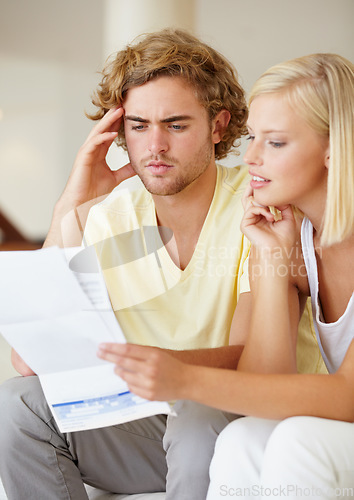 Image of Finance, paper and couple with documents in a house for future planning, investment or asset management. Paperwork, insurance and people in a living room for bills, mortgage or home loan application
