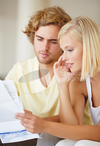 Image of Paper, finance and couple with documents in a house for future planning, investment or asset management. Paperwork, insurance and people in a living room for bills, mortgage or home loan application