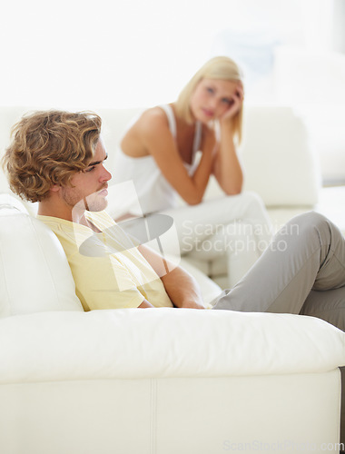 Image of Angry couple, stress and divorce fight on a sofa with argument, anxiety or cheating depression in their home. Marriage crisis, dispute and overthinking man ignore toxic woman liar in a living room