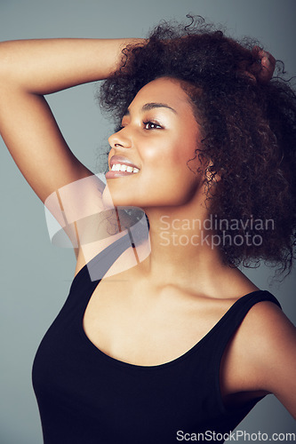 Image of Woman, afro and hair care for natural beauty in studio or curly treatment, grey background or mockup space. Female person, smile and grooming confidence or healthy wellness, texture pride or volume