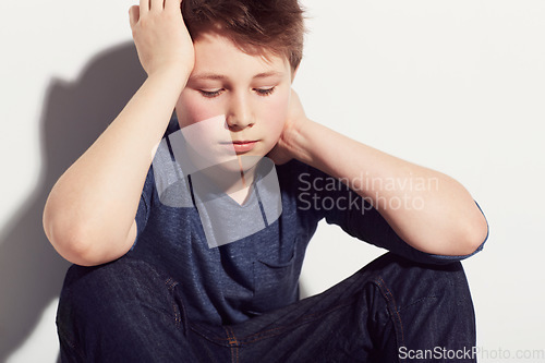 Image of Sad, teenager and boy thinking in studio or sitting in white background with anxiety from fail in school. Mental health, stress and kid with worry from mistake or depressed emotions and ideas