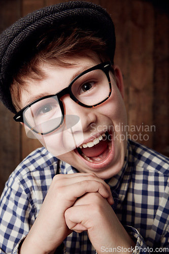 Image of Glasses, portrait and happy for boy in funny comic and vintage fashion in eyewear by wooden background. Child, face or laughter for comedy or retro clothes, spectacles or joke for smart for vision