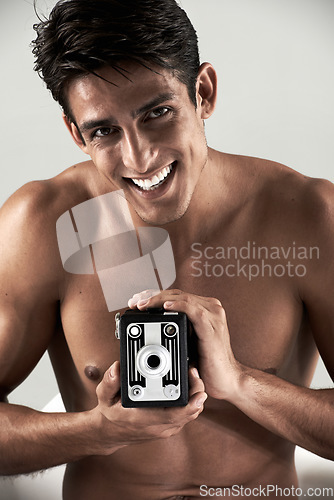 Image of Shirtless, man and portrait with vintage camera for sexy, photography or recording happiness. Muscular, model and smile with retro photographer, hobby or topless person with creative film project