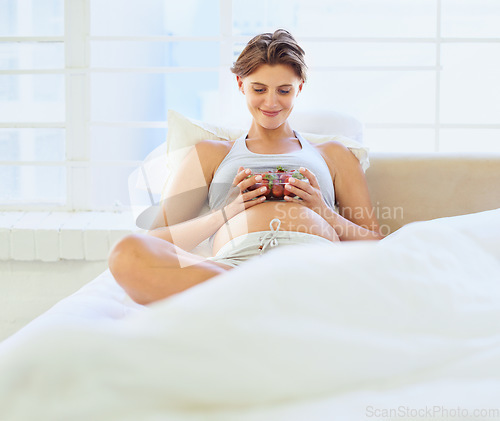 Image of Pregnant woman, strawberry and fruit in bedroom with relax wellness for vegan nutrition in house. Young person, happy and prenatal health diet with hungry for food and vitamins for breakfast in home